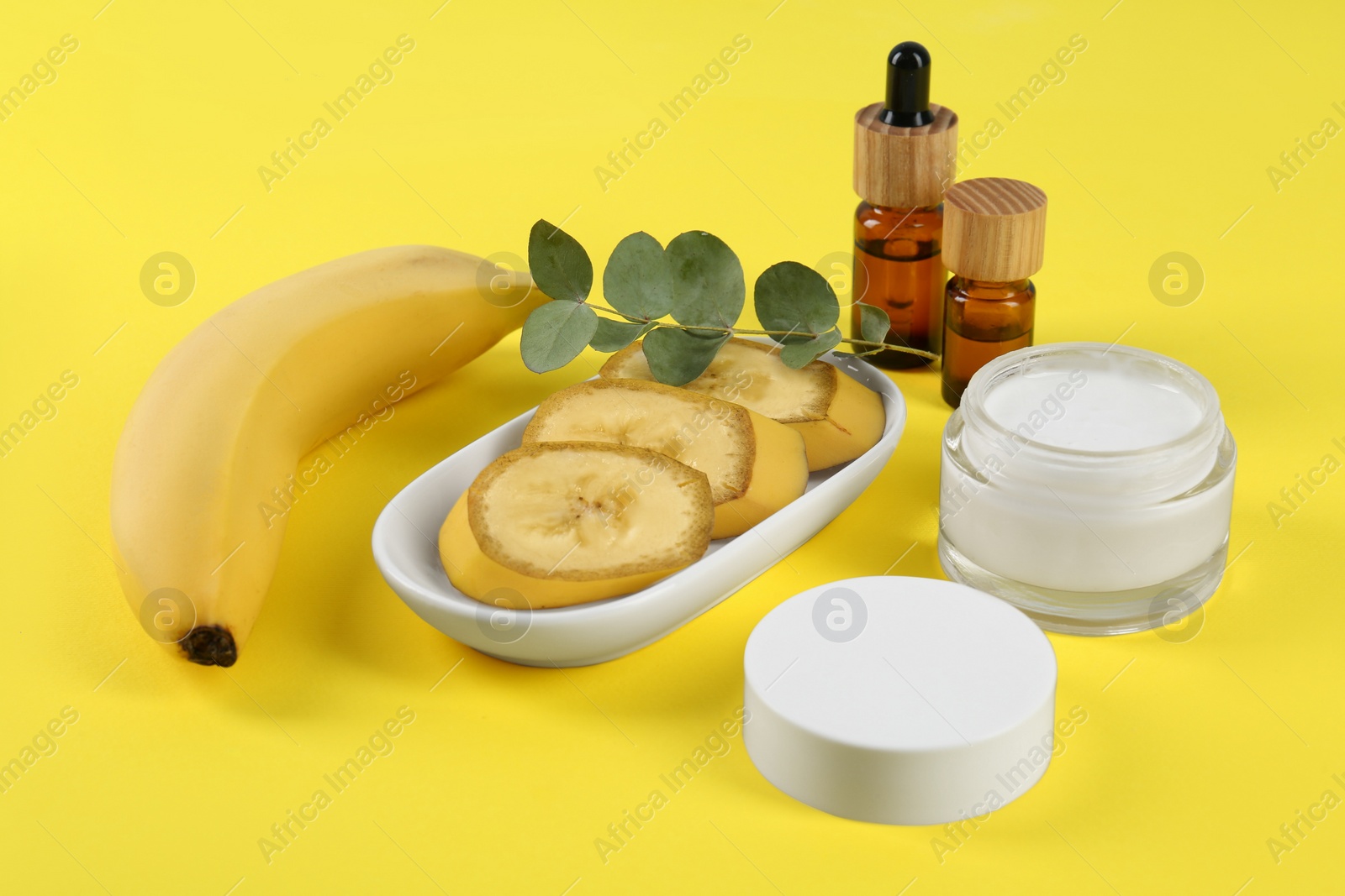 Photo of Composition with homemade cosmetic products and fresh ingredients on yellow background. DIY beauty recipe