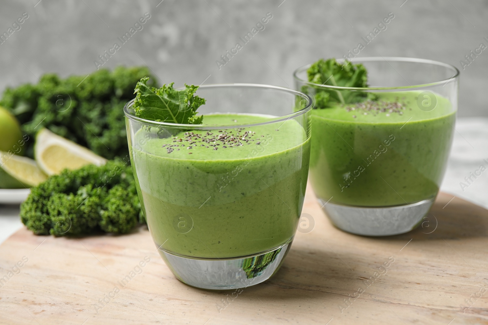 Photo of Tasty kale smoothie with chia seeds on table, closeup