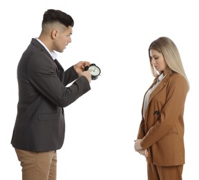 Businessman with alarm clock scolding employee for being late on white background