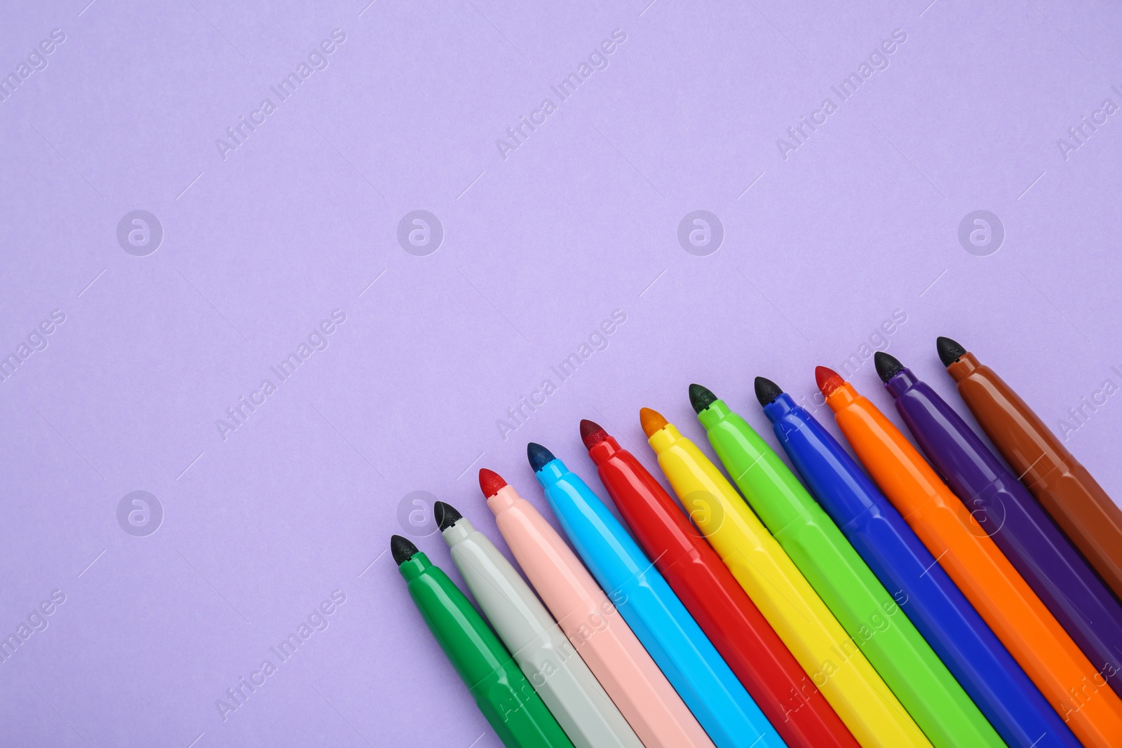 Photo of Different colorful markers on light background, flat lay. Space for text