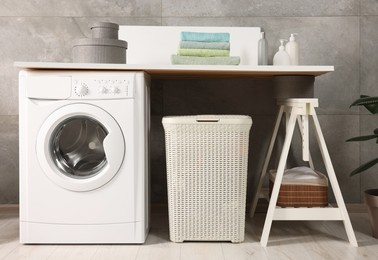 Stylish laundry room with modern washing machine. Interior design