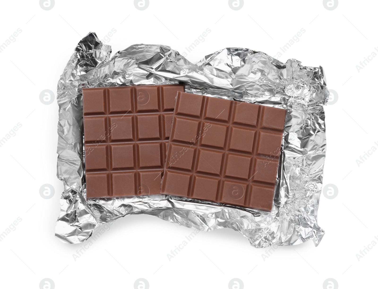 Photo of Pieces of tasty milk chocolate bar with foil on white background, top view