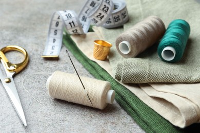 Photo of Spools of threads and sewing tools on light table