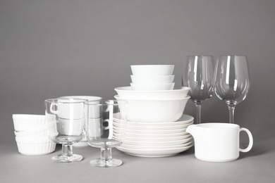 Set of clean tableware on grey background. Washing dishes