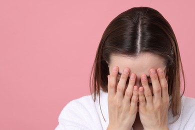 Photo of Woman suffering from hair loss problem on pink background. Space for text