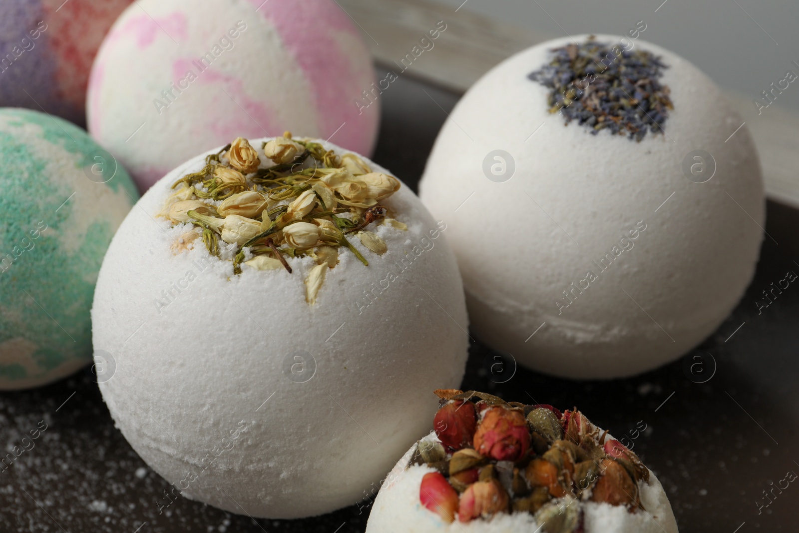 Photo of Dark plate with different bath bombs, closeup