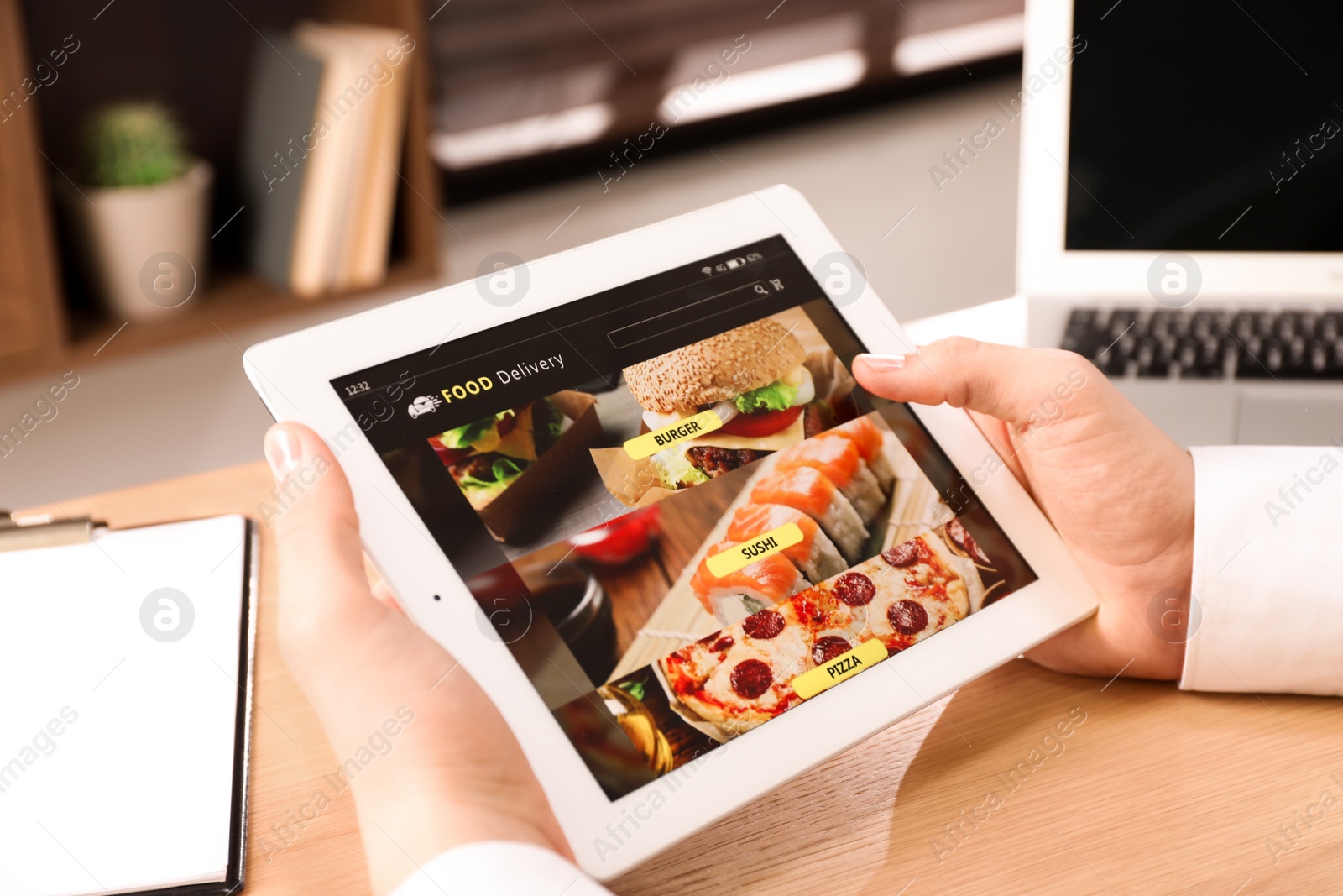 Photo of Man using tablet for ordering food online at work, closeup. Concept of delivery service