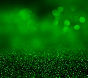 Image of St. Patrick day. Shiny green glitter, closeup. Bokeh effect