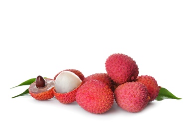 Pile of fresh ripe lychees with green leaves on white background