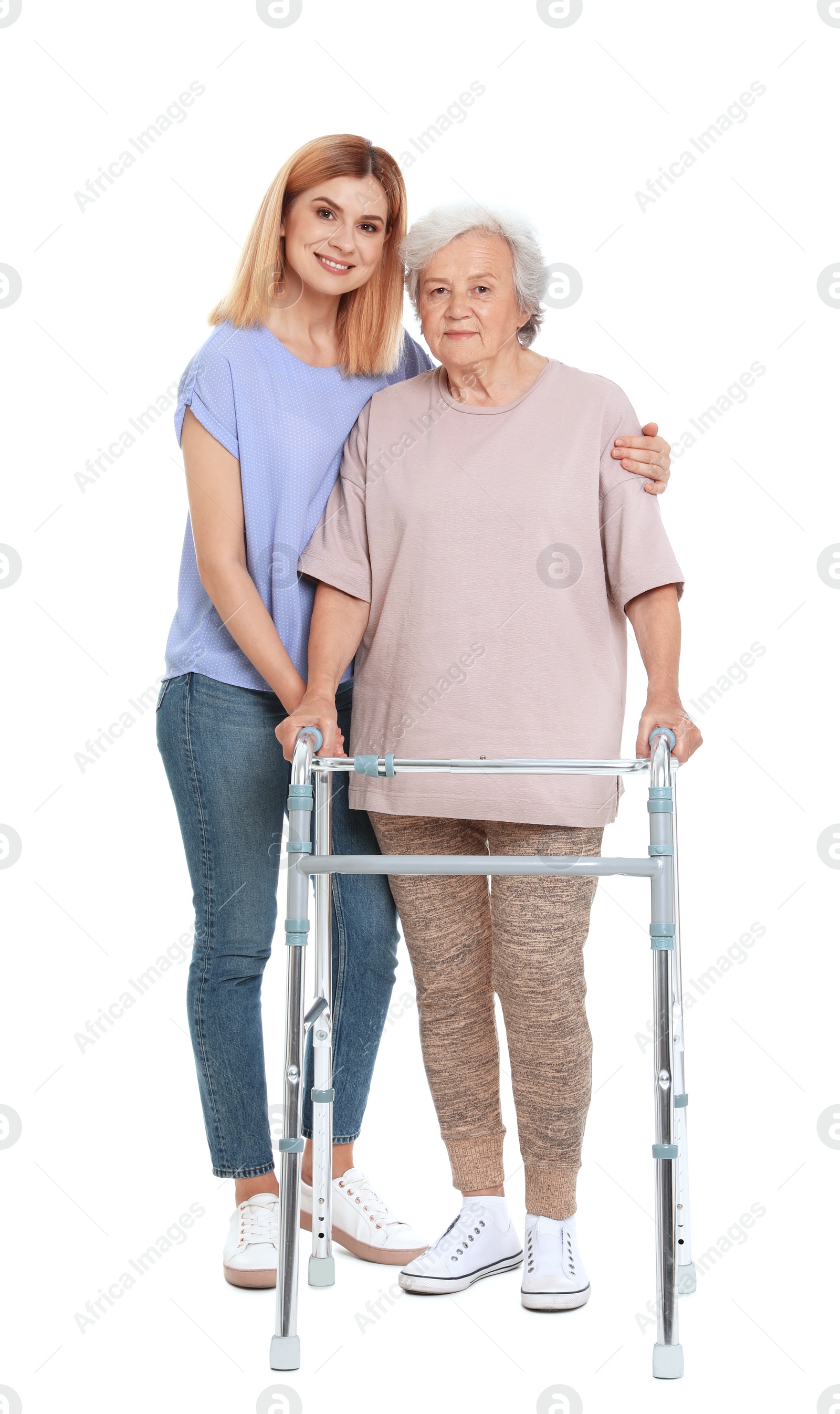 Photo of Caretaker helping elderly woman with walking frame on white background