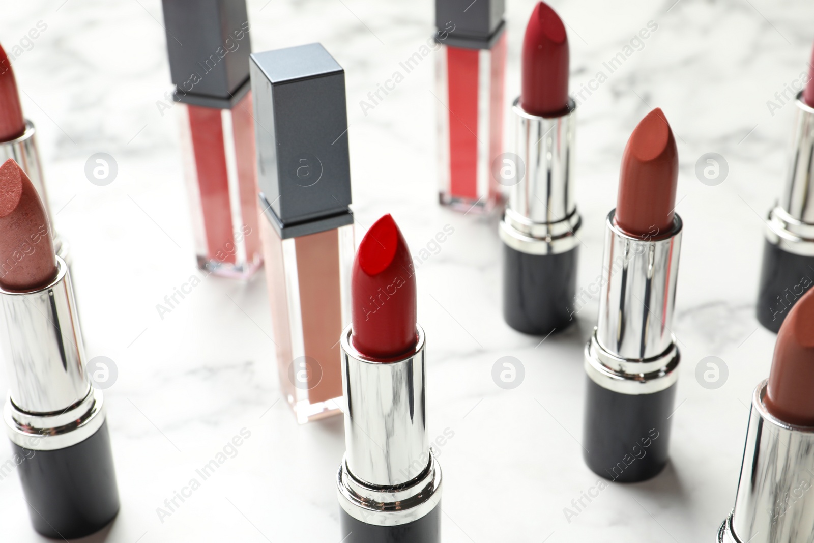 Photo of Different lipsticks on light background. Cosmetic product