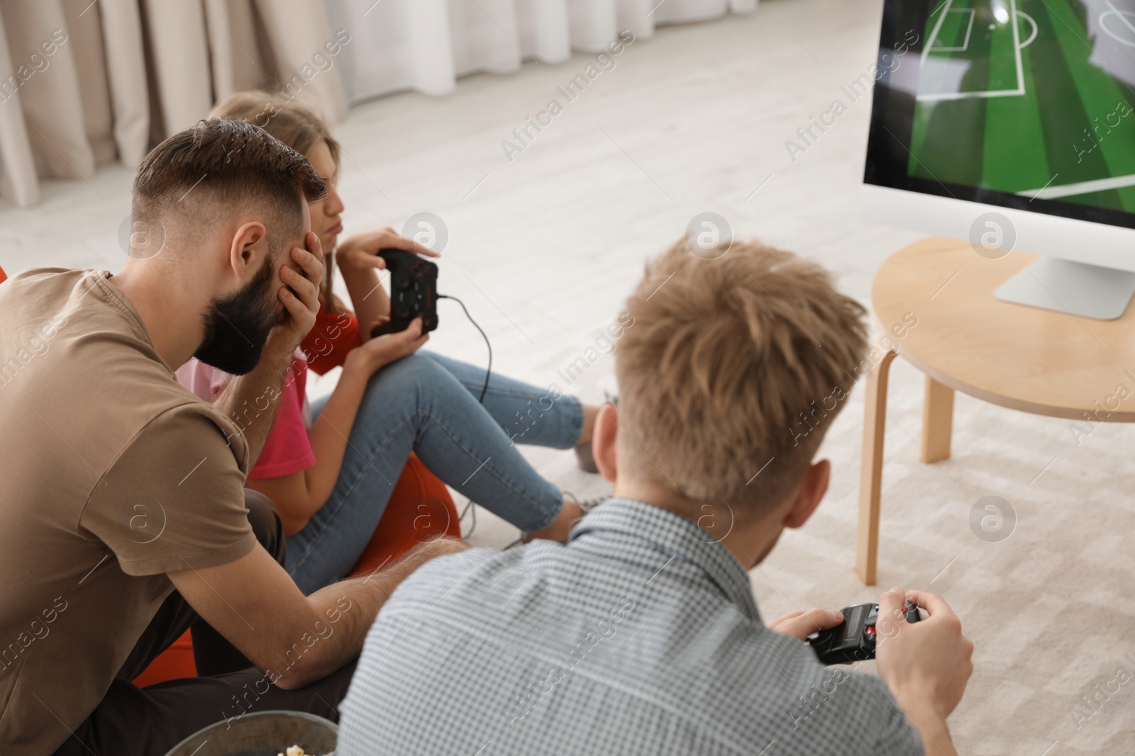 Photo of Emotional friends playing video games at home