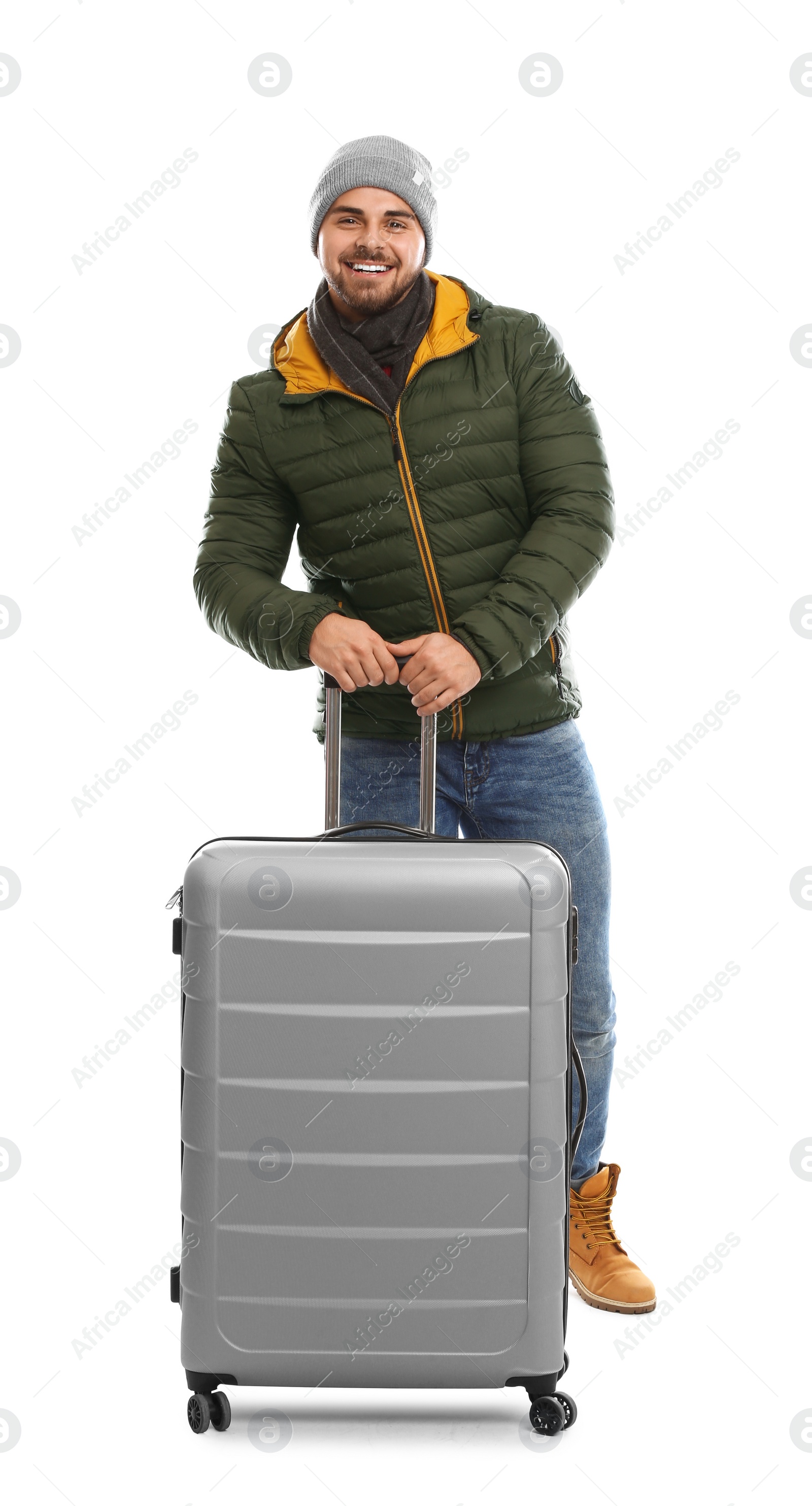 Photo of Young man in warm clothes with suitcase on white background. Winter vacation