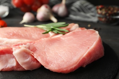 Fresh raw cut meat on slate plate, closeup