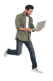 Photo of Handsome man with laptop running on white background