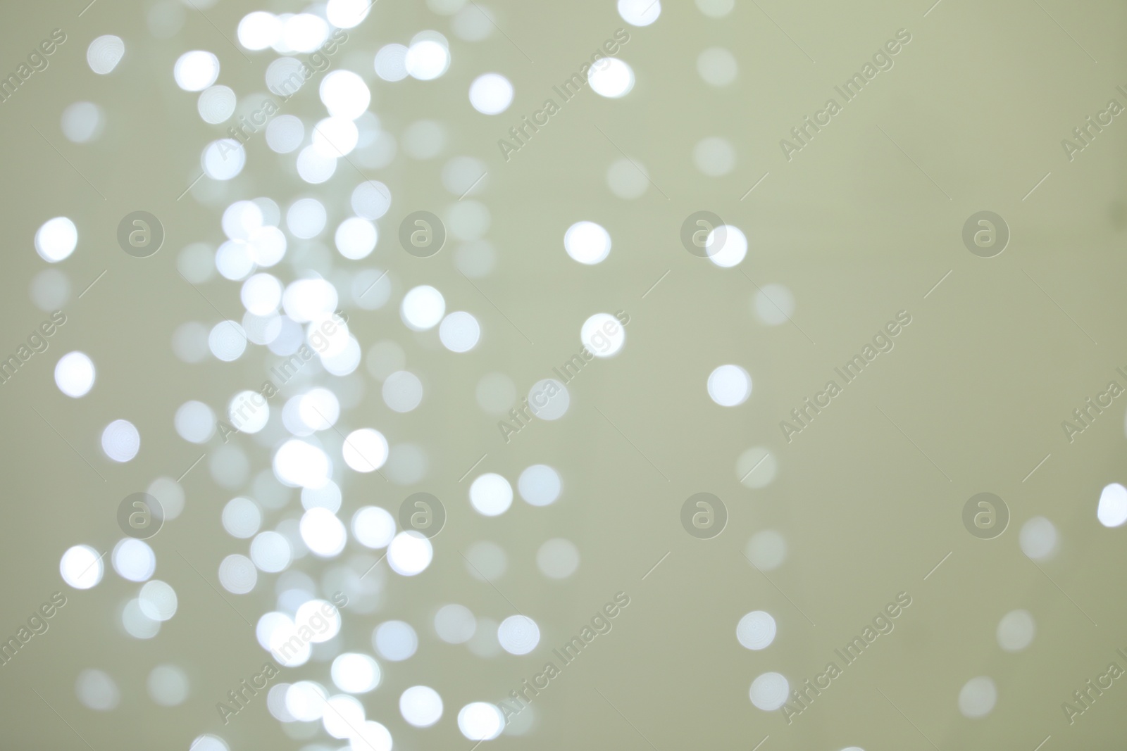 Photo of Blurred view of shiny silver lights. Bokeh effect