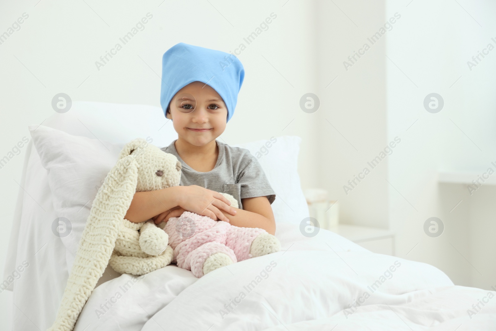 Photo of Childhood cancer. Girl with toy bunny in hospital