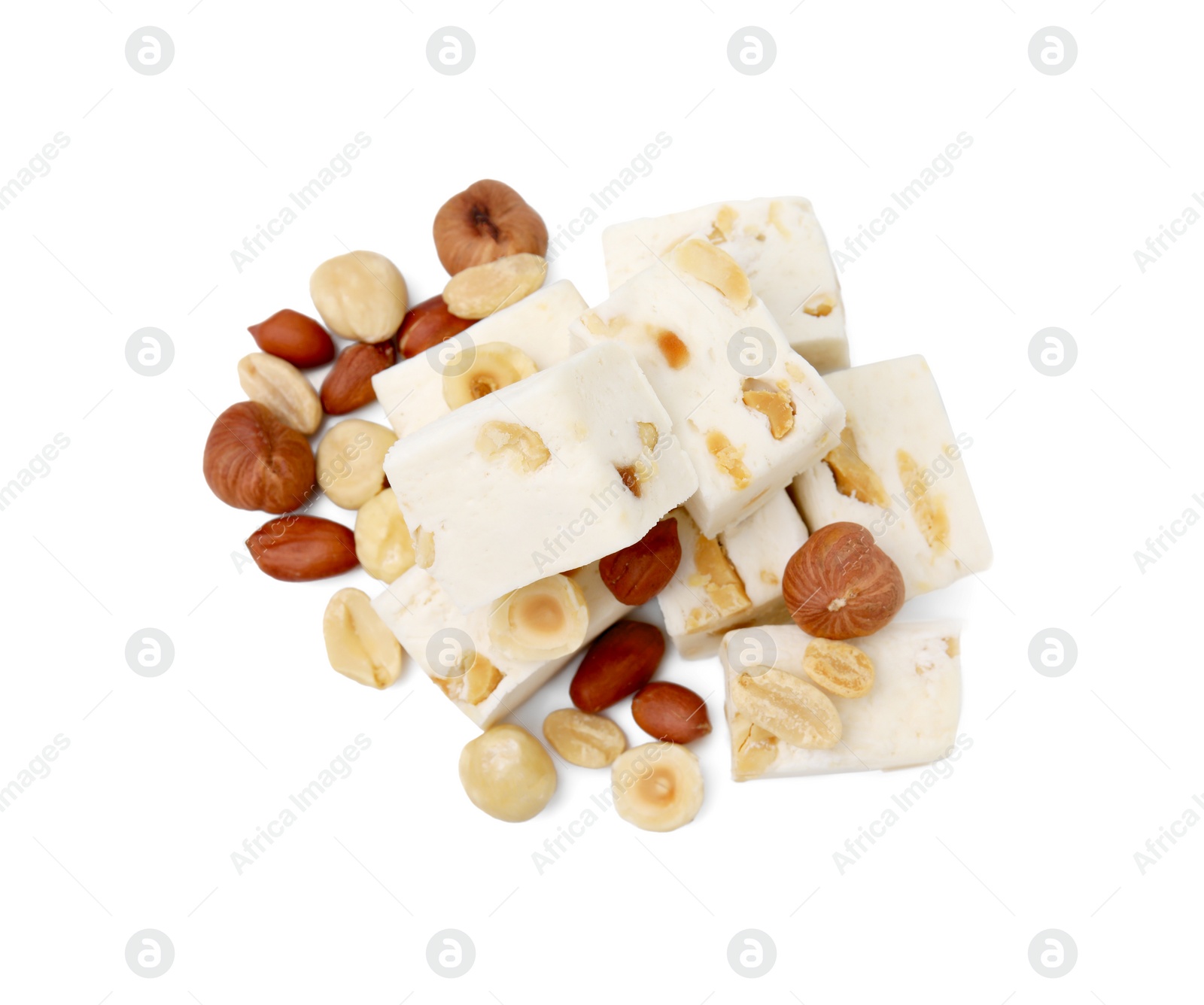 Photo of Pieces of delicious nougat and nuts on white background, top view