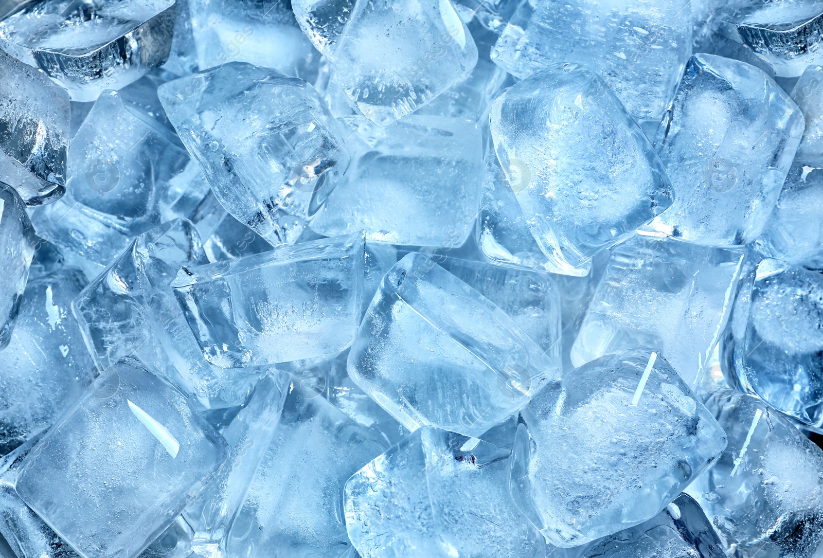 Photo of Many ice cubes on color background, top view