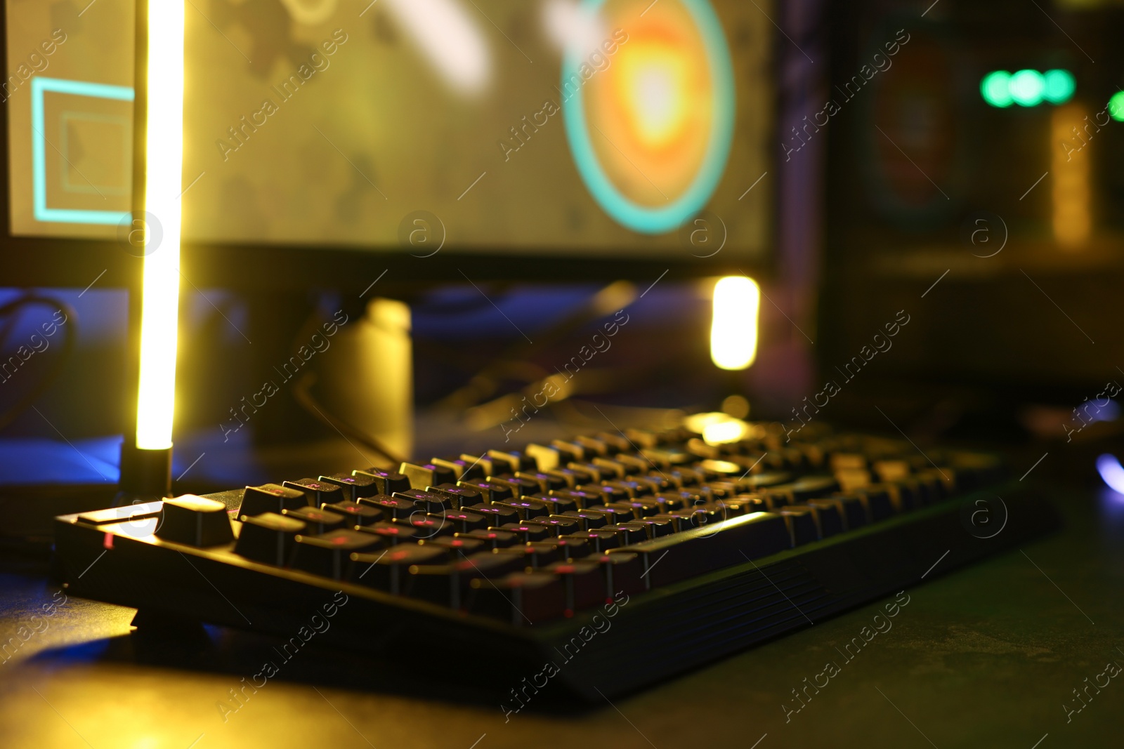 Photo of Playing video games. Computer keyboard on table, closeup