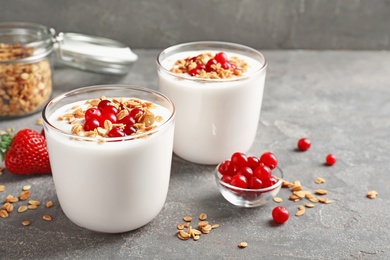 Glasses with yogurt, berries and granola on table