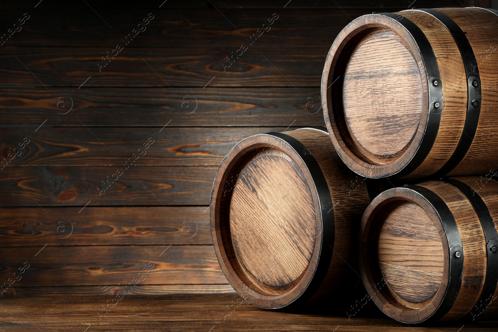 Photo of Wooden barrels on table, space for text