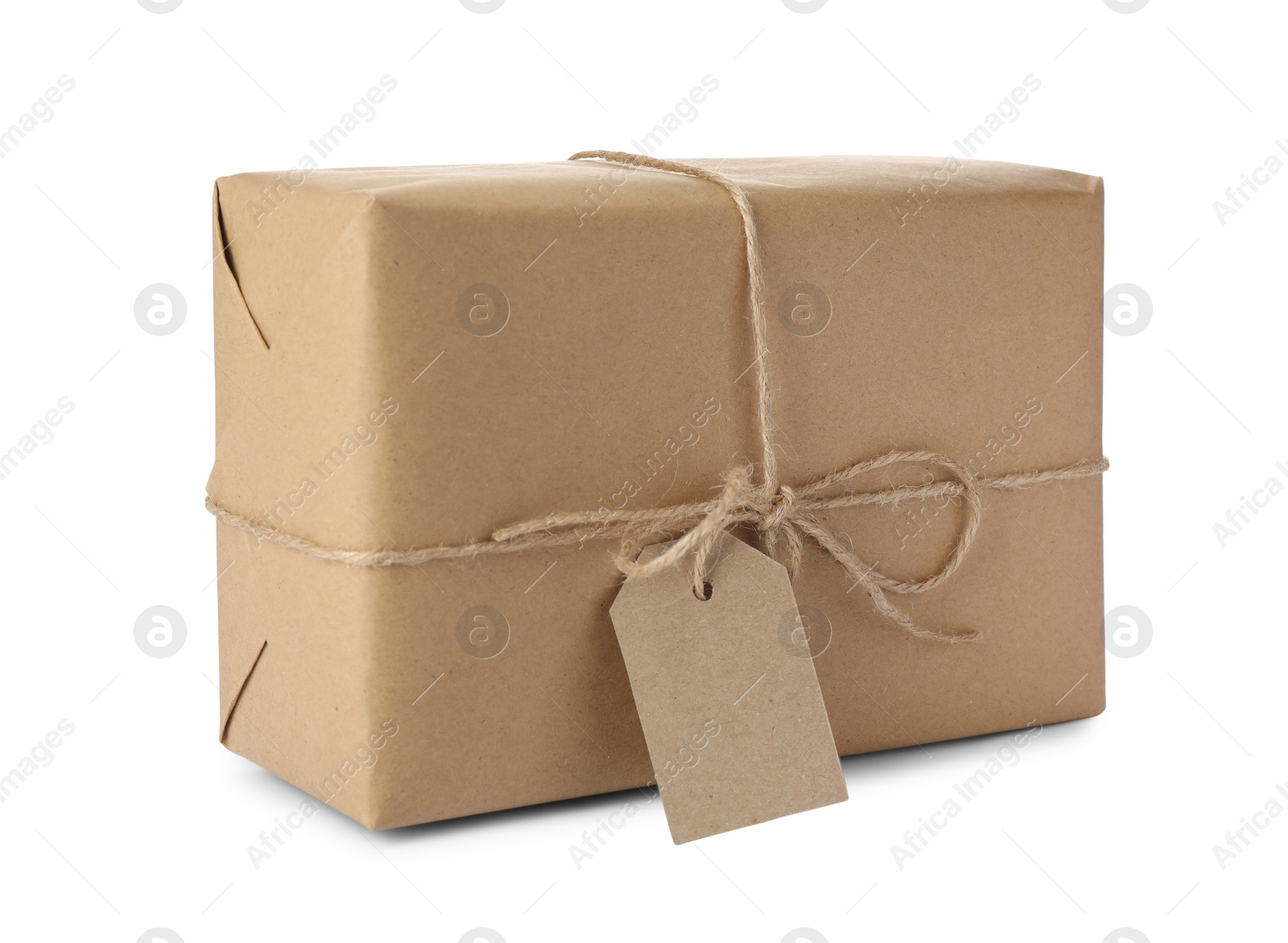 Photo of Parcel wrapped in kraft paper with tag on white background