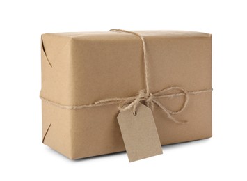 Photo of Parcel wrapped in kraft paper with tag on white background