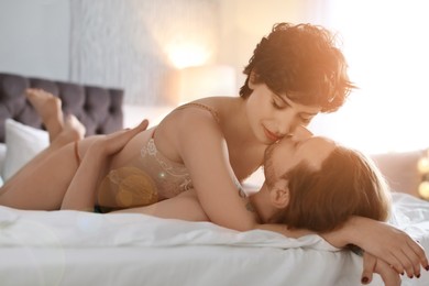 Image of Lovely young couple on bed at home