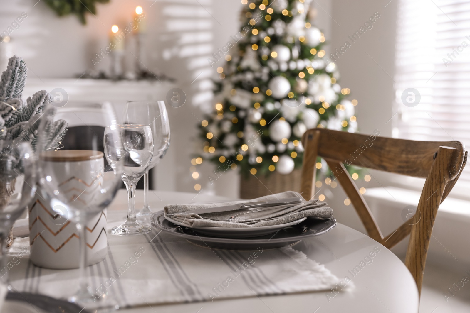 Photo of Festive table setting and beautiful Christmas decor indoors. Interior design