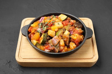 Dish with tasty ratatouille on black table