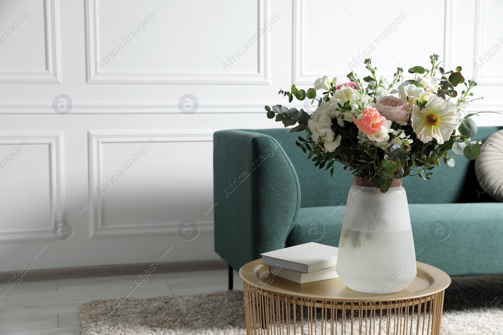 Photo of Bouquet of beautiful flowers on table indoors. Space for text