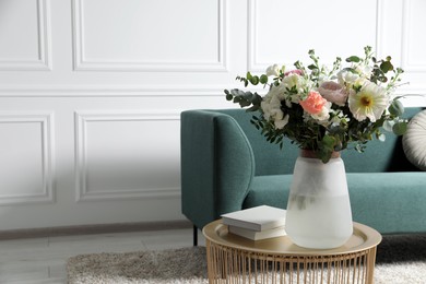 Bouquet of beautiful flowers on table indoors. Space for text