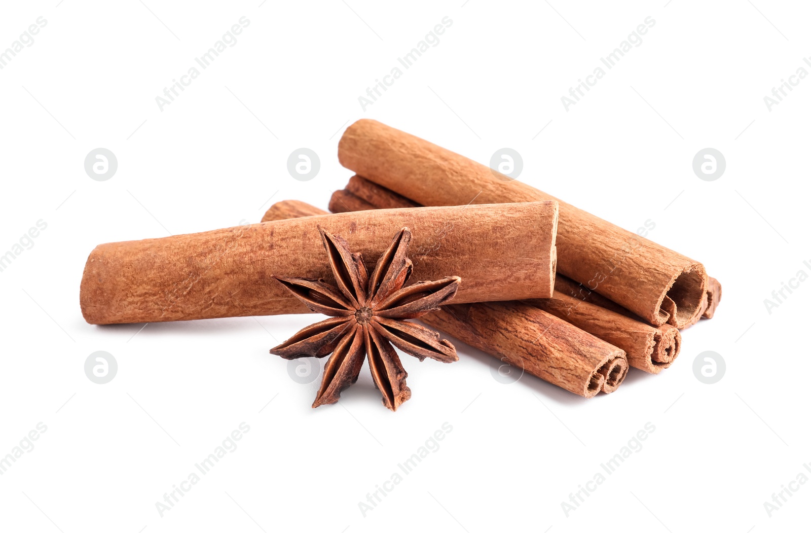 Photo of Aromatic cinnamon sticks and anise star isolated on white