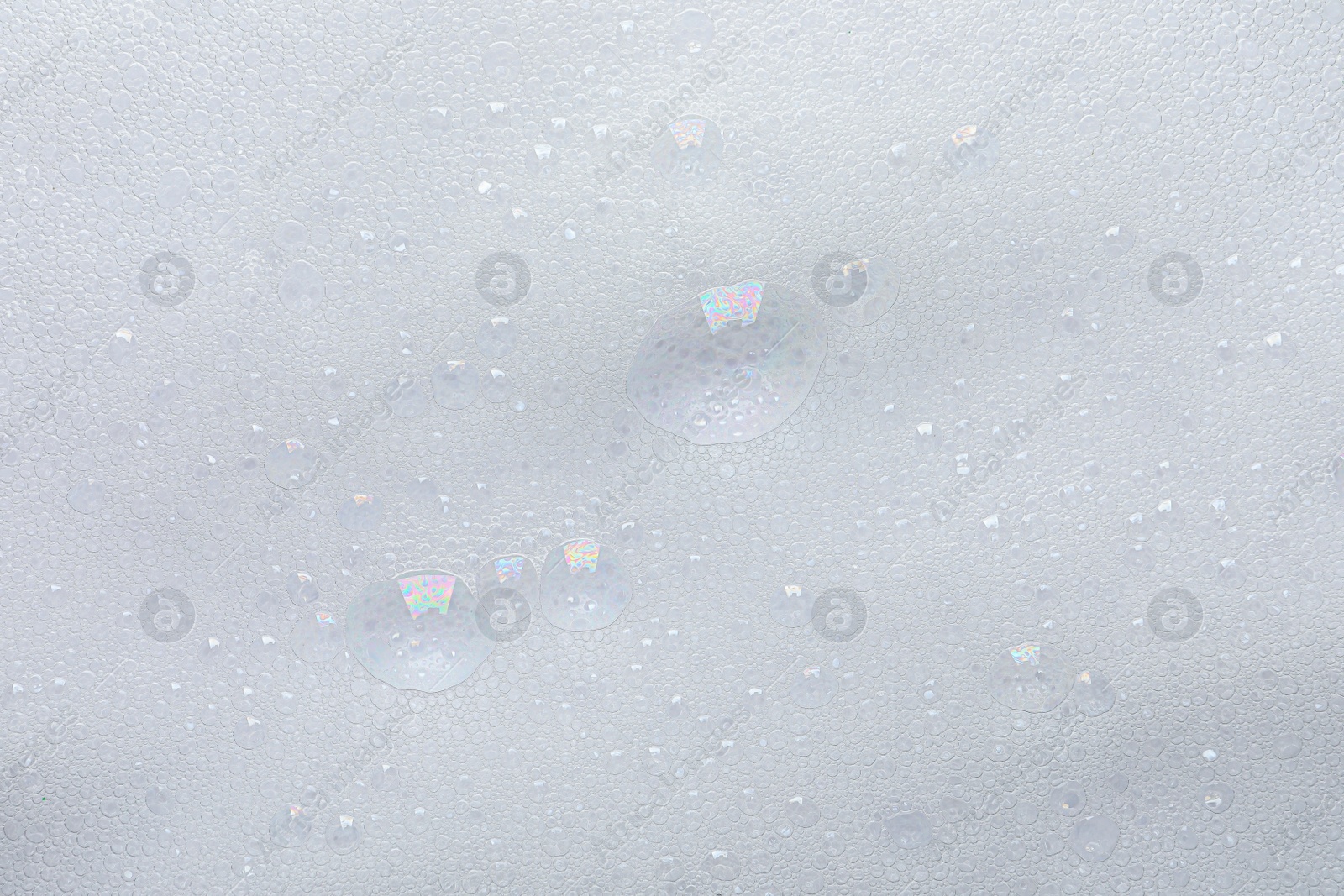 Photo of Fluffy soap foam as background, top view