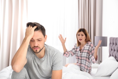 Photo of Couple having argument in bedroom. Relationship problems