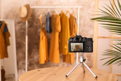 Taking photo of stylish clothes indoors, focus on camera