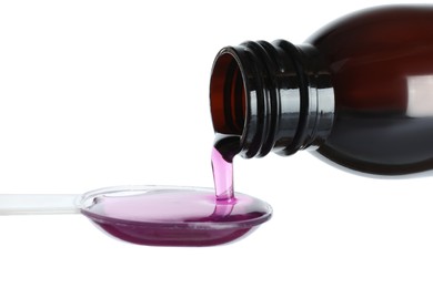 Pouring cough syrup into dosing spoon on white background