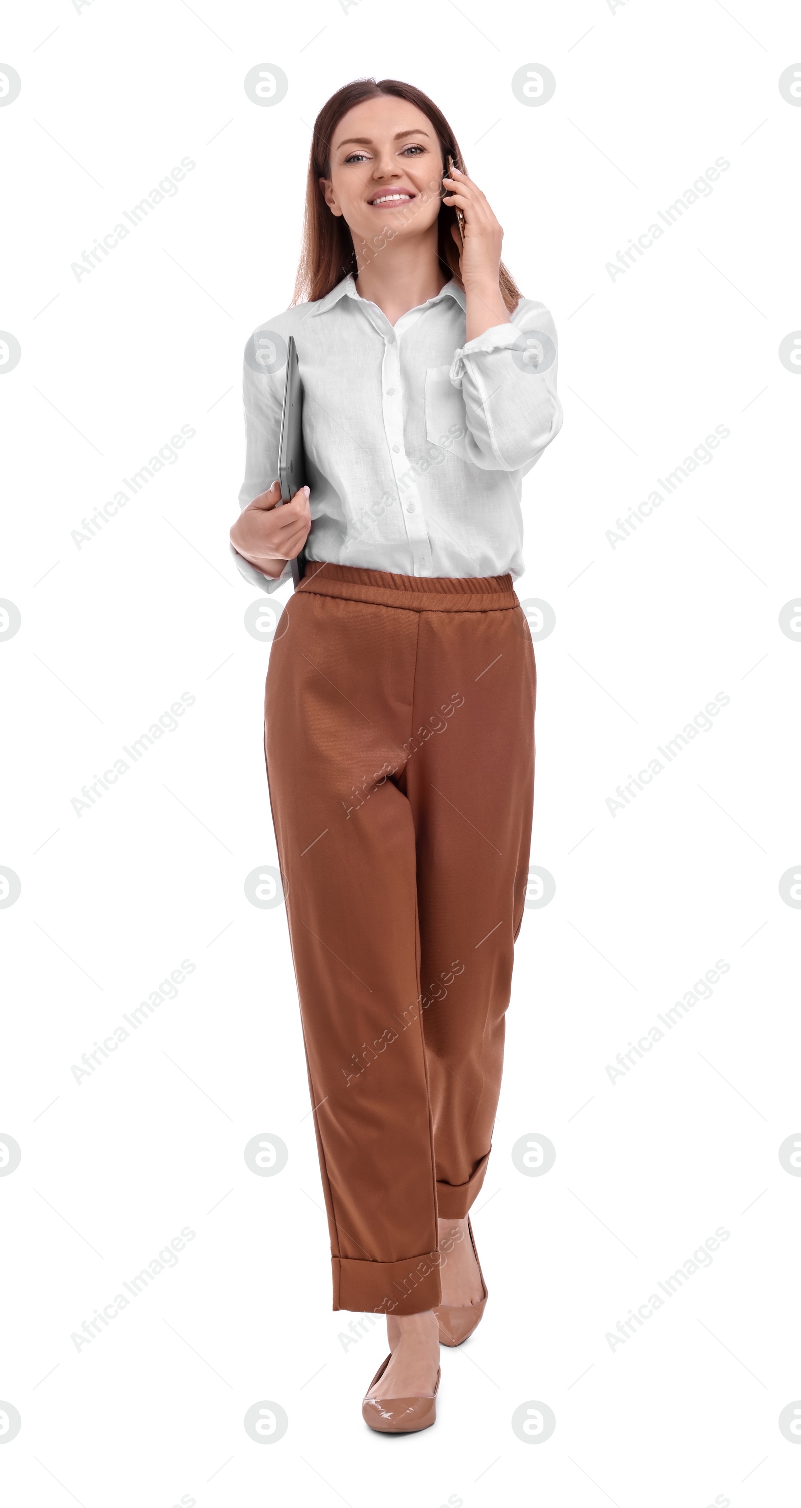 Photo of Beautiful businesswoman with laptop talking on phone against white background