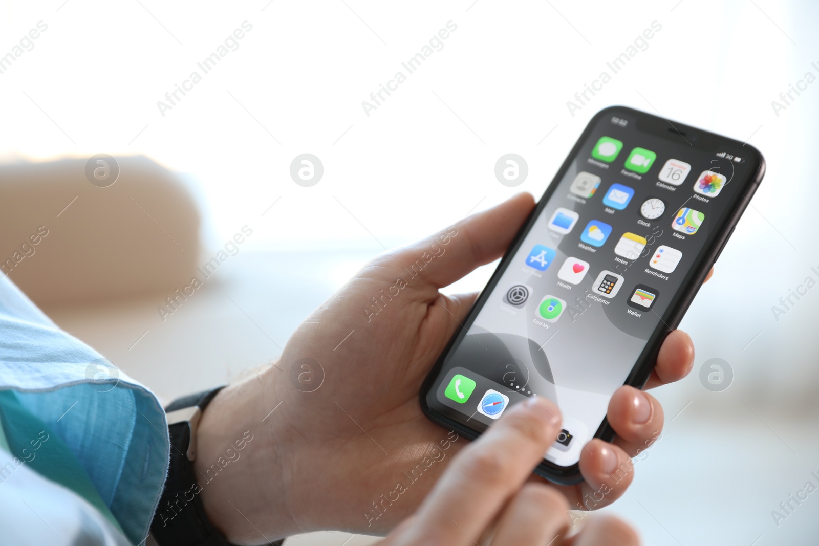 Photo of MYKOLAIV, UKRAINE - MARCH 16, 2020: Man holding iPhone 11 with home screen indoors, closeup