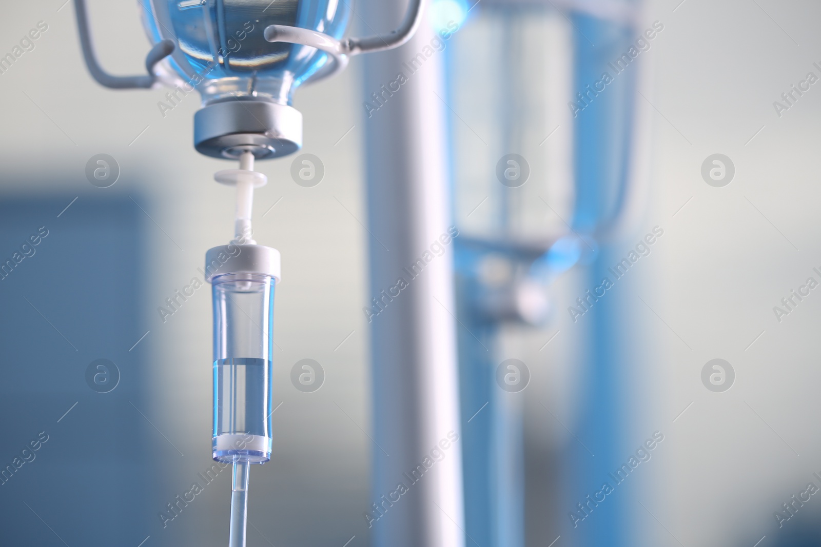 Photo of IV drip against blurred background, space for text