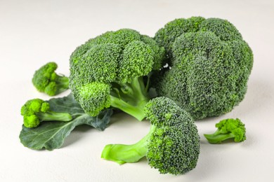 Fresh raw green broccoli on white table