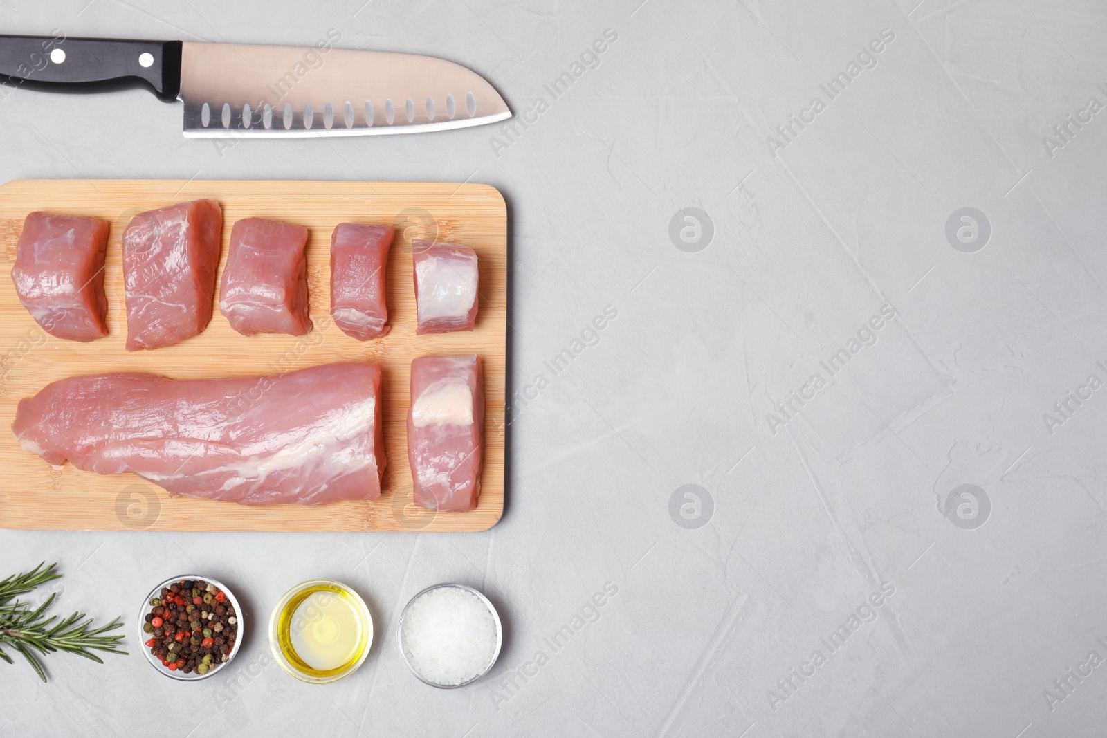 Photo of Flat lay composition with fresh raw meat and space for text on gray background