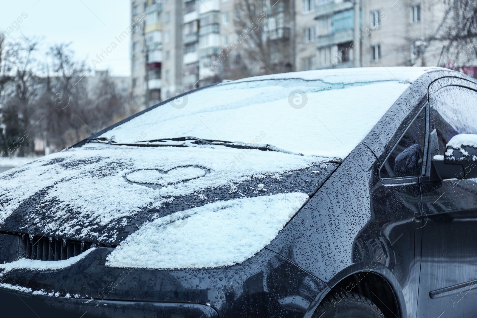 Photo of Heart drawn on car covered with snow outdoors