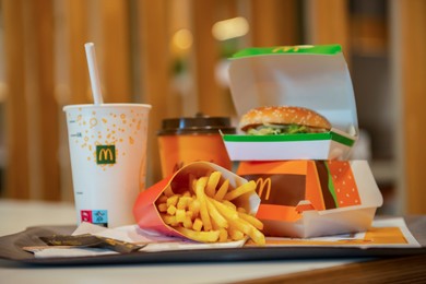 WARSAW, POLAND - SEPTEMBER 04, 2022: McDonald's French fries, burgers and drinks on table indoors