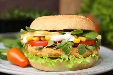 Photo of Tasty vegan burger with vegetables, patty and microgreens on white plate, closeup