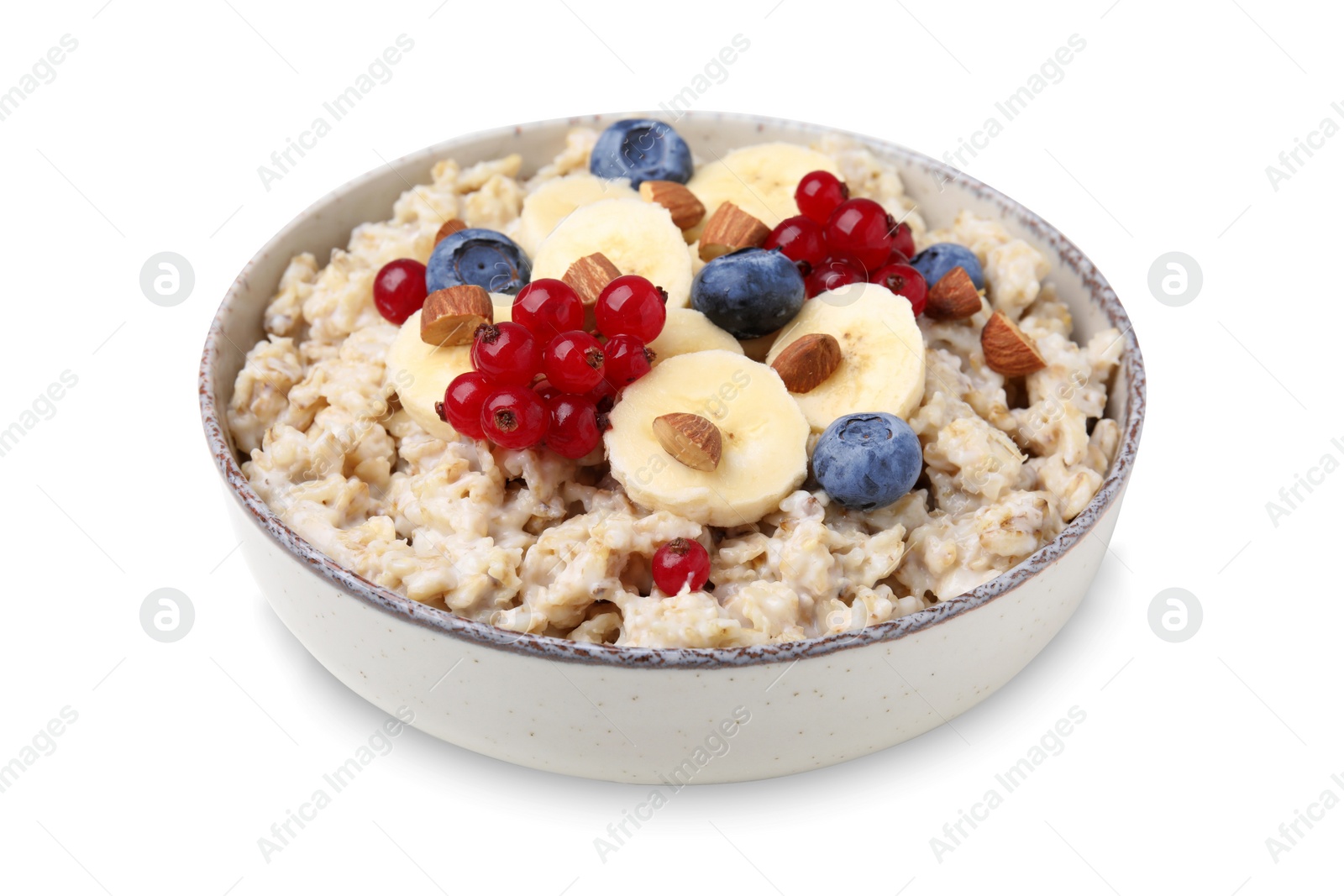 Photo of Ceramic bowl with oatmeal, berries and banana slices isolated on white