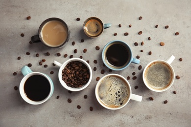 Flat lay composition with cups of coffee on gray background. Food photography