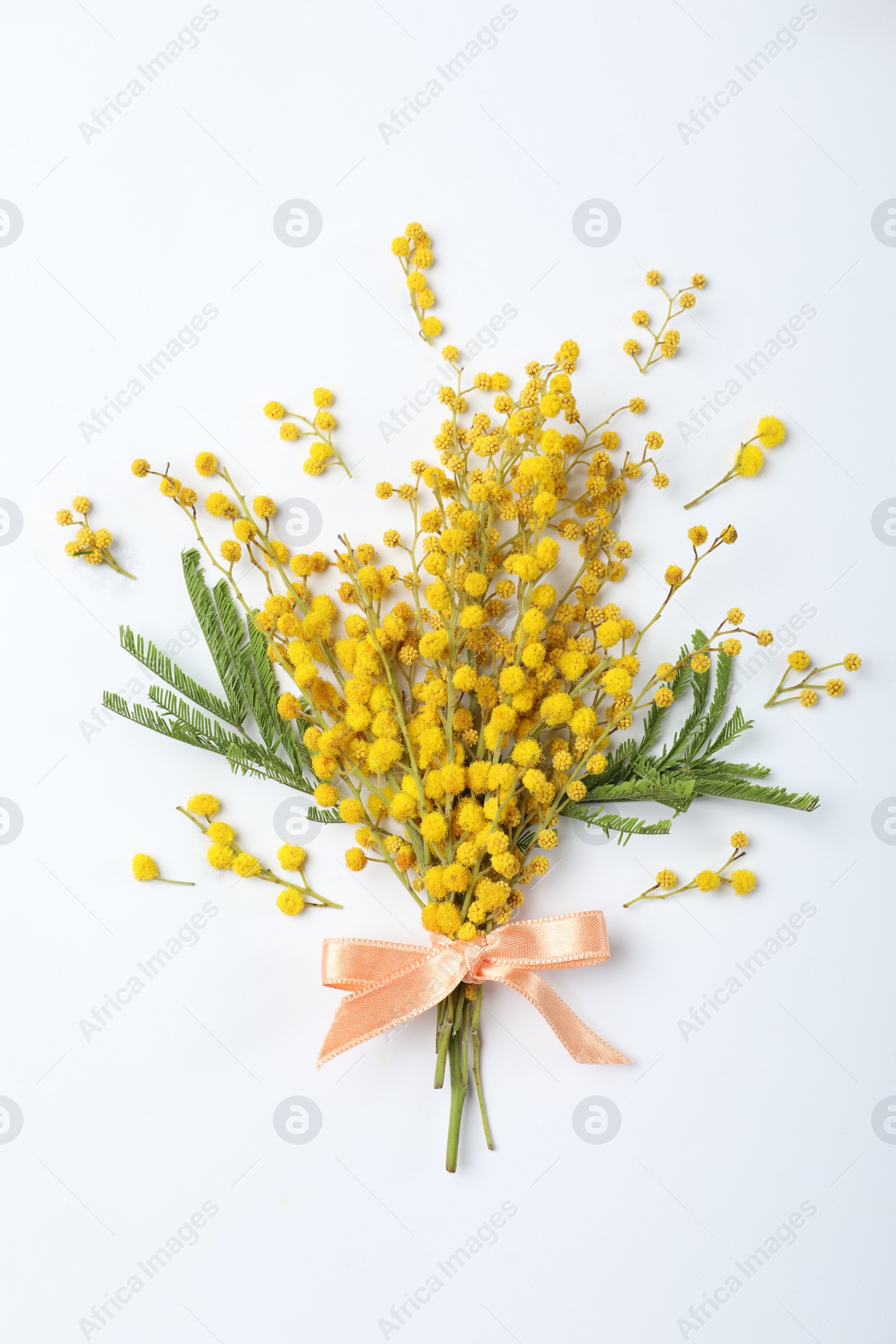 Photo of Bouquet of beautiful mimosa flowers on white background, top view