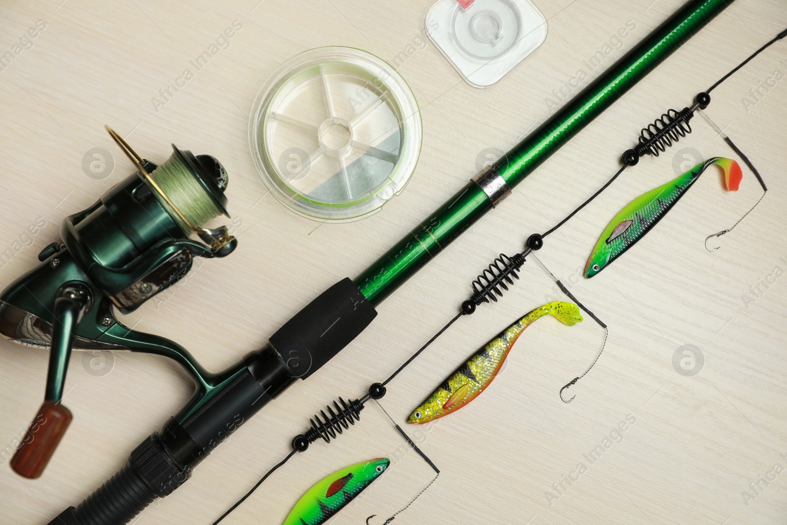 Photo of Fishing tackle on wooden background, flat lay